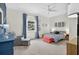 Spacious bedroom with a seating area, large window, ceiling fan and ample natural light at 13640 2Nd E Ave, Bradenton, FL 34212