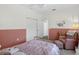 Bedroom featuring a brass bed frame, seating area and closet at 13640 2Nd E Ave, Bradenton, FL 34212