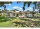 Charming one-story home featuring a well-manicured lawn, and a welcoming front porch at 13640 2Nd E Ave, Bradenton, FL 34212