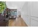 Elegant foyer with wood floors, large bookcase, and stylish decor at 13640 2Nd E Ave, Bradenton, FL 34212