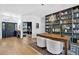 Bright foyer featuring wood floors, a statement bookcase, and a view into the office at 13640 2Nd E Ave, Bradenton, FL 34212