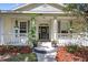 Inviting front porch with decorative plants and a wreath on the front door at 13640 2Nd E Ave, Bradenton, FL 34212
