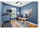 Home office with blue walls, hard wood floors, and a treadmill at 13640 2Nd E Ave, Bradenton, FL 34212