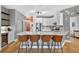 Stylish kitchen with stainless steel appliances, quartz countertops, and modern bar stools at 13640 2Nd E Ave, Bradenton, FL 34212