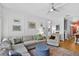 Comfortable living room with a large sectional sofa, accent chair, and elegant decor at 13640 2Nd E Ave, Bradenton, FL 34212