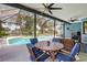 Inviting covered patio featuring an outdoor dining set, perfect for enjoying meals poolside at 13640 2Nd E Ave, Bradenton, FL 34212