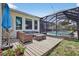 Comfortable outdoor seating area with a view of the screened pool and backyard, perfect for relaxing at 13640 2Nd E Ave, Bradenton, FL 34212