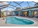 Beautiful screened-in pool and patio area with ample seating for entertaining, and outdoor fans at 13640 2Nd E Ave, Bradenton, FL 34212