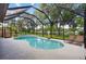 Screened-in pool area with lounge chairs, offering a private and relaxing outdoor oasis at 13640 2Nd E Ave, Bradenton, FL 34212