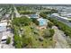 Aerial shot highlighting the community pool, playground, and picnic shelters, nestled among lush greenery and waterways at 1404 Dartmouth Dr, Bradenton, FL 34207