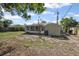 Spacious backyard featuring a screened porch and a storage shed, ready for outdoor enjoyment and customization at 1404 Dartmouth Dr, Bradenton, FL 34207