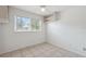 This spacious bedroom offers tile floors, a large window, and a wall shelving unit at 1404 Dartmouth Dr, Bradenton, FL 34207