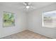 Bright bedroom with tiled floors and two windows at 1404 Dartmouth Dr, Bradenton, FL 34207