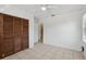 Well-lit bedroom featuring tile floors, ceiling fan, closet and an entrance to a bathroom at 1404 Dartmouth Dr, Bradenton, FL 34207