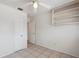 This bedroom features tile floors, a ceiling fan, a closet, and built-in shelving at 1404 Dartmouth Dr, Bradenton, FL 34207