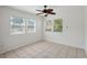 Bright bedroom featuring tile flooring, neutral walls, and three windows for ample natural light at 1404 Dartmouth Dr, Bradenton, FL 34207