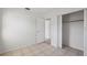 Bright bedroom with a tile floor, an open closet, and access to another room at 1404 Dartmouth Dr, Bradenton, FL 34207