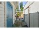Side exterior view of a house featuring a blue door and shed at 1404 Dartmouth Dr, Bradenton, FL 34207