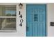 Stylish entry door featuring a vibrant blue finish, classic detailing, and a secure mail slot at 1404 Dartmouth Dr, Bradenton, FL 34207
