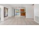 Spacious living room features tile flooring that flows to a dining area and screened in lanai at 1404 Dartmouth Dr, Bradenton, FL 34207