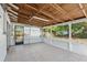 Screened-in patio with tile flooring, leading to backyard at 1404 Dartmouth Dr, Bradenton, FL 34207