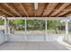 Enclosed back patio featuring a wooden roof and a lovely view of the backyard at 1404 Dartmouth Dr, Bradenton, FL 34207
