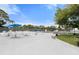 Relaxing pool deck with white lounge chairs, tables, and umbrellas, offering a perfect spot for poolside lounging at 1404 Dartmouth Dr, Bradenton, FL 34207