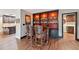 Home wet bar area with hardwood floors and cabinet storage at 1509 Shadow Ridge Cir, Sarasota, FL 34240