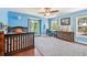 Bright bedroom with blue walls, wooden floors, a ceiling fan, area rug, two windows and desk at 1509 Shadow Ridge Cir, Sarasota, FL 34240