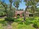 Beautiful view of the property surrounded by mature trees and lush landscaping at 1509 Shadow Ridge Cir, Sarasota, FL 34240