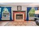 Cozy fireplace framed by windows with blue curtains and hardwood flooring at 1509 Shadow Ridge Cir, Sarasota, FL 34240