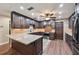 Modern kitchen with granite countertops, dark wood cabinets, and stainless appliances at 1509 Shadow Ridge Cir, Sarasota, FL 34240