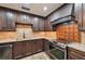 Modern kitchen featuring stainless steel appliances and dark wood cabinetry at 1509 Shadow Ridge Cir, Sarasota, FL 34240