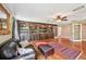 Inviting living room with custom built-in bookshelves and gleaming hardwood floors at 1509 Shadow Ridge Cir, Sarasota, FL 34240