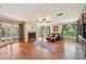 Spacious living room with hardwood floors, fireplace, and French doors to pool at 1509 Shadow Ridge Cir, Sarasota, FL 34240