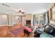 Cozy living room with a brick fireplace, hardwood floors, and French doors at 1509 Shadow Ridge Cir, Sarasota, FL 34240