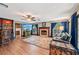 Large living room with a fireplace, hardwood floors, and wet bar area at 1509 Shadow Ridge Cir, Sarasota, FL 34240