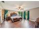 Spacious main bedroom with natural light, wood flooring, and a decorative headboard at 1509 Shadow Ridge Cir, Sarasota, FL 34240