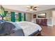Spacious main bedroom with natural light, wood flooring, and a decorative headboard at 1509 Shadow Ridge Cir, Sarasota, FL 34240