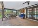 Enjoy outdoor dining on this covered patio with ceiling fans, seating area, and a view of the pool at 1509 Shadow Ridge Cir, Sarasota, FL 34240