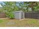 Outdoor shed providing convenient storage in a well-maintained backyard with privacy fencing at 1509 Shadow Ridge Cir, Sarasota, FL 34240