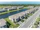 Community aerial of townhomes surrounding a serene lake; lush landscaping adds to the appeal at 15164 Sunny Day Dr, Bradenton, FL 34211