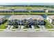 An aerial view of attractive townhomes along a lake with manicured landscaping at 15164 Sunny Day Dr, Bradenton, FL 34211
