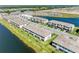 Aerial view of community townhomes overlooking a lake and green landscaping at 15164 Sunny Day Dr, Bradenton, FL 34211
