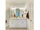 Bright bathroom featuring double vanity with granite countertop and walk-in shower at 15164 Sunny Day Dr, Bradenton, FL 34211