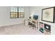Simple bedroom featuring neutral carpet, white walls, and window with work-from-home setup at 15164 Sunny Day Dr, Bradenton, FL 34211
