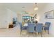 Elegant dining room with stylish chandelier, and a view into the living room at 15164 Sunny Day Dr, Bradenton, FL 34211