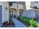 Inviting walkway with decorative plants leading to front doors with dark trim and hardware at 15164 Sunny Day Dr, Bradenton, FL 34211