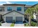 Attractive two-story townhome with neutral paint, dark trim, and well-maintained landscaping at 15164 Sunny Day Dr, Bradenton, FL 34211