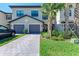 Charming townhome with a stone paver driveway, well-kept lawn, and inviting landscaping at 15164 Sunny Day Dr, Bradenton, FL 34211